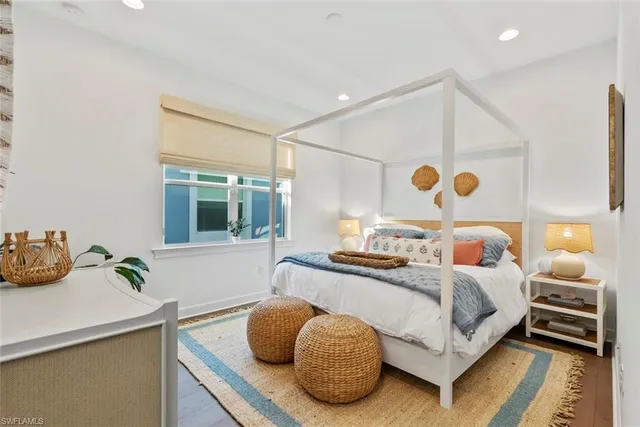 a bedroom with a bed and a large window