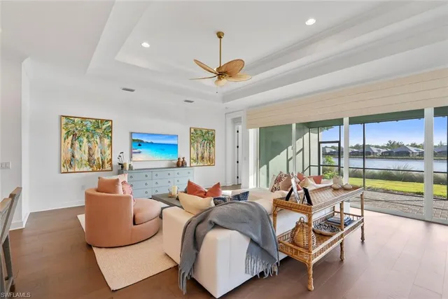 a living room with furniture and a floor to ceiling window
