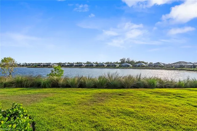 a view of a lake with houses in the back