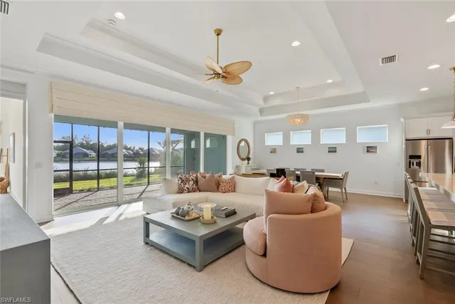 a living room with furniture and a large window with outer view