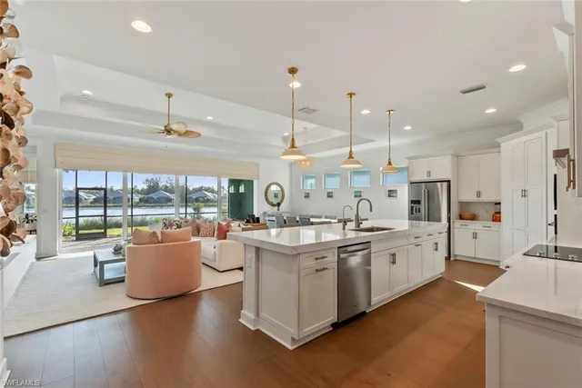 a large kitchen with stainless steel appliances kitchen island granite countertop a large cabinets a sink and a stove