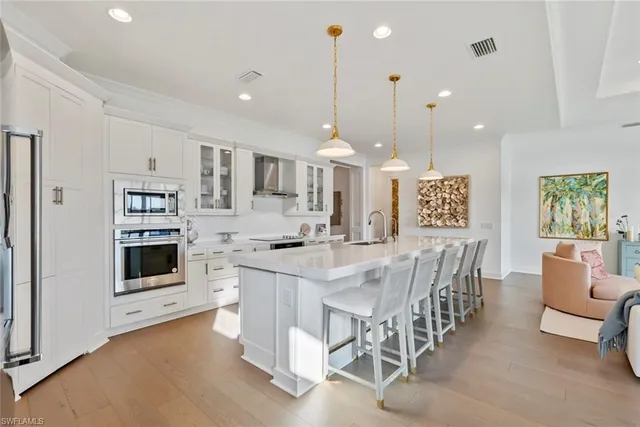 a large kitchen with a table and chairs