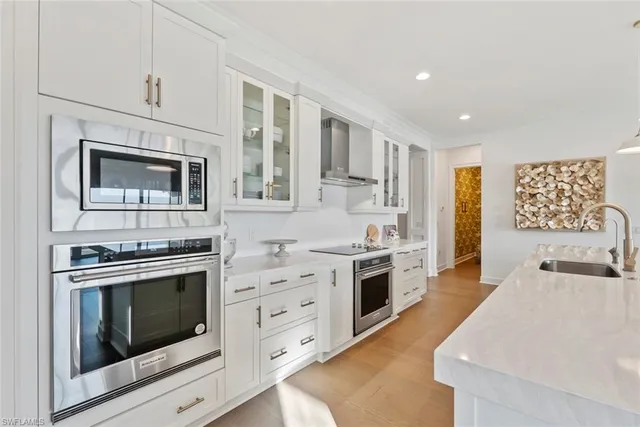 a kitchen with stainless steel appliances granite countertop a stove and a sink