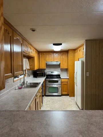 a kitchen with stainless steel appliances a stove and a refrigerator