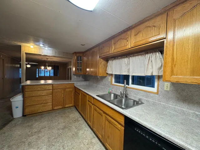 a kitchen with stainless steel appliances granite countertop a sink and cabinets