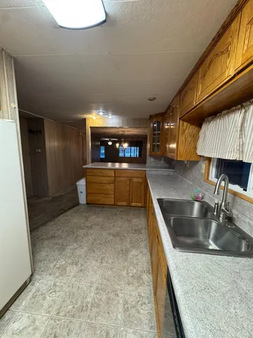 a kitchen with stainless steel appliances granite countertop a sink and a stove