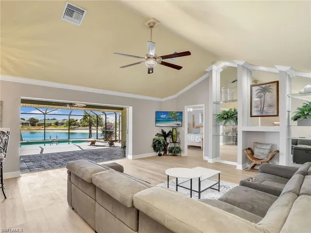 a living room with furniture large window and flat screen tv