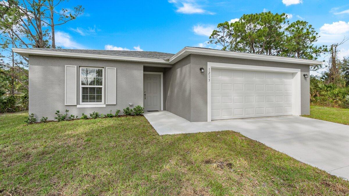 1213 Ragen Road Southeast Palm Bay, FL 32909 - Photo 2 of 26 front view of a house with a yard