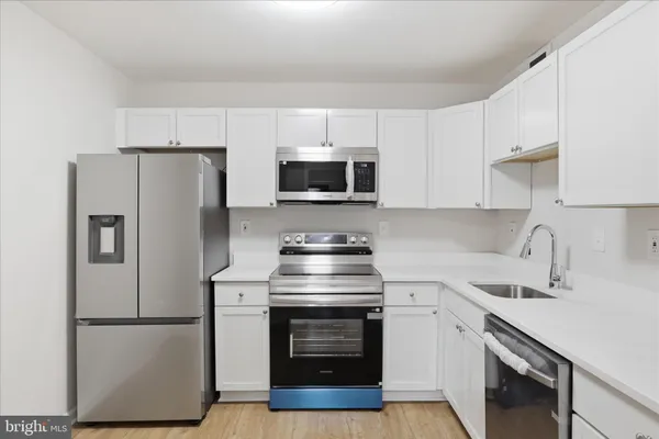 a kitchen with a stove and a refrigerator
