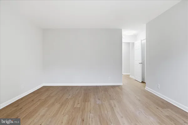 a view of a room with wooden floor