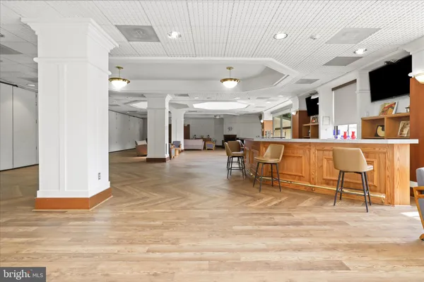 a dining room with furniture and wooden floor
