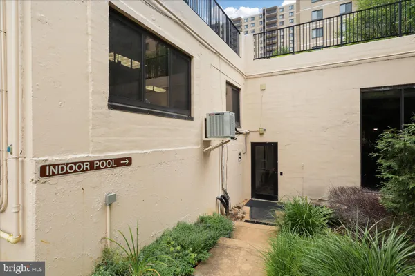 a view of a hallway with wooden floor and stairs
