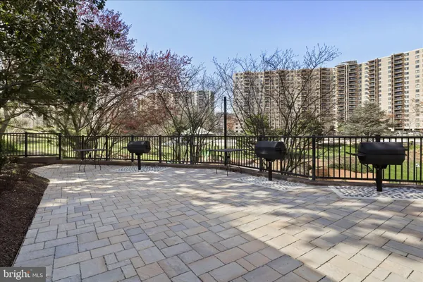 a view of a tennis court with a large building