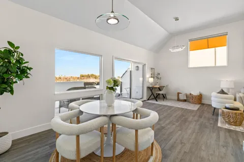 a dining room with furniture and wooden floor
