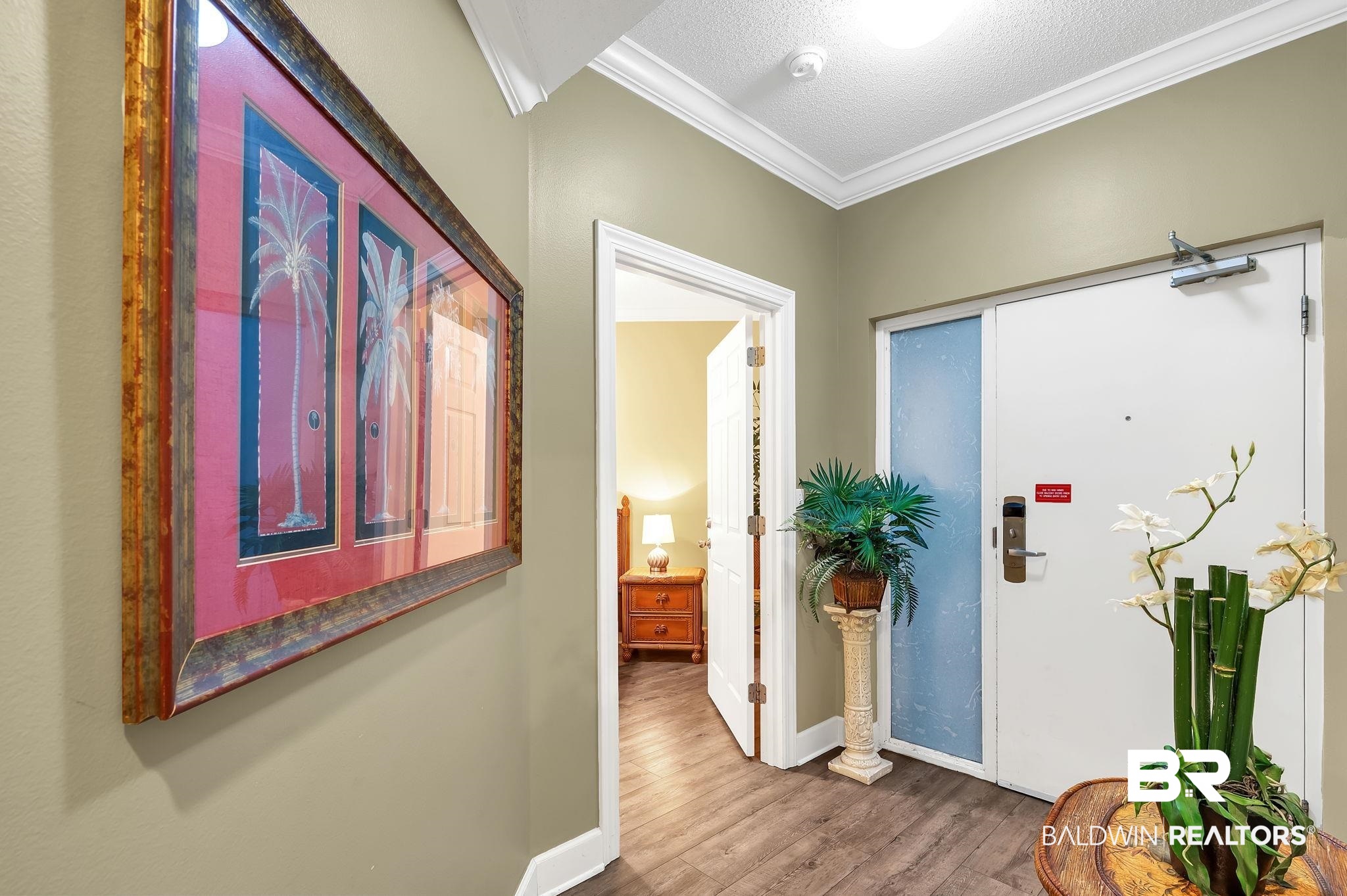27580 Canal Road, Unit 1214 AND BOAT SLIP #62 Orange Beach, AL 36561 - Photo 6 of 67 Hallway featuring baseboards, a textured ceiling, ornamental molding, and wood finished floors
