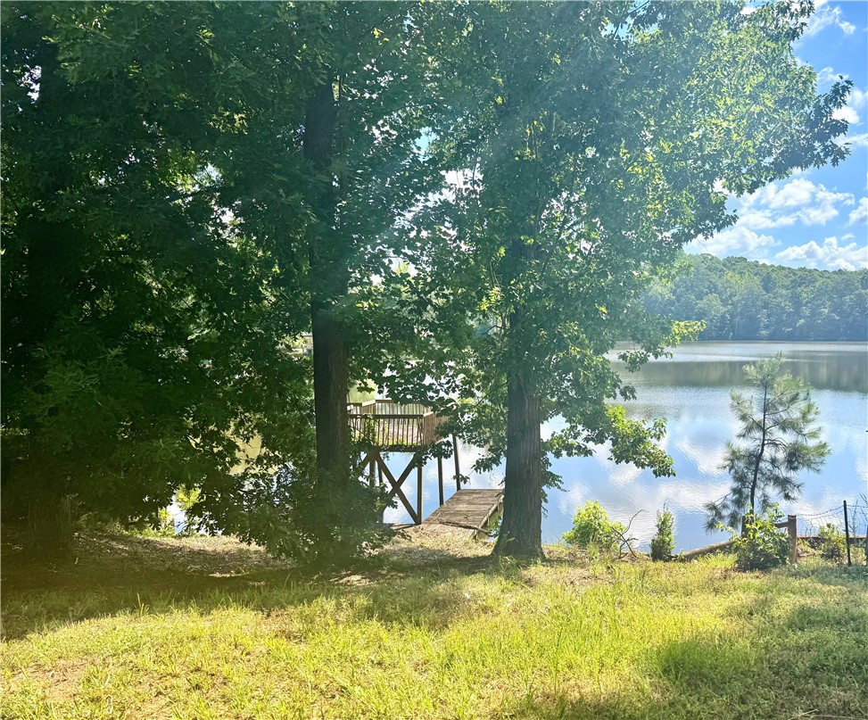 136 Elgin Drive Anderson, SC 29621 - Photo 3 of 6 A secluded lakeside retreat featuring a private dock and mature trees for ultimate tranquility.