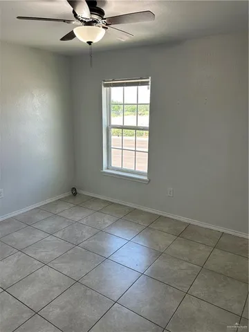 a view of a livingroom with a ceiling fan and window