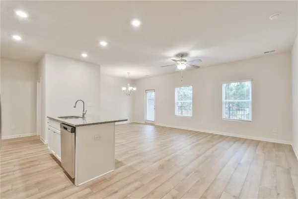 a view of a kitchen with sink and wooden floor