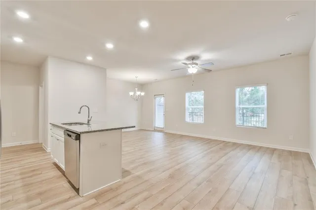 a view of a kitchen with sink and wooden floor