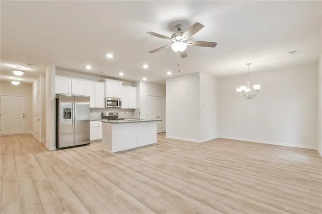a view of a kitchen with a sink and a refrigerator