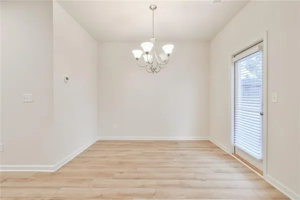 a view of a room with wooden floor and a window