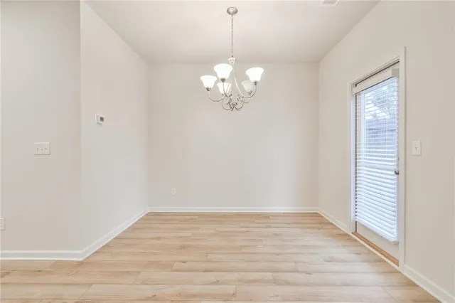 a view of a room with wooden floor and a window