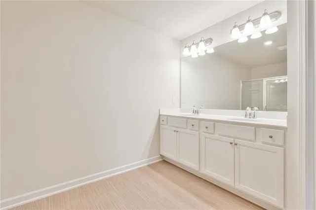 a bathroom with a sink vanity and a mirror