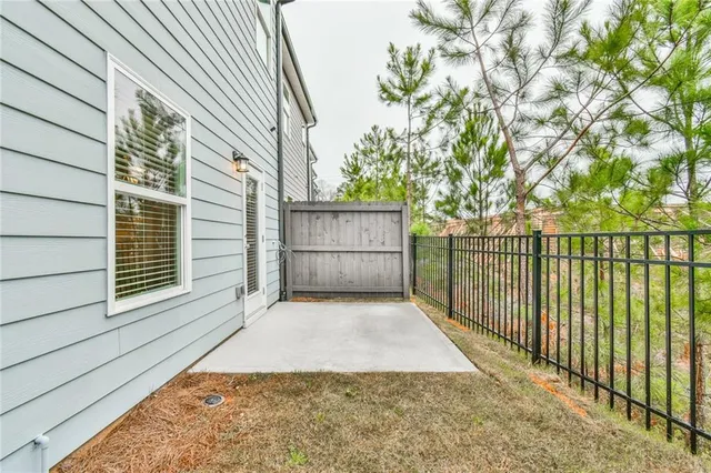 a view of backyard and wooden fence