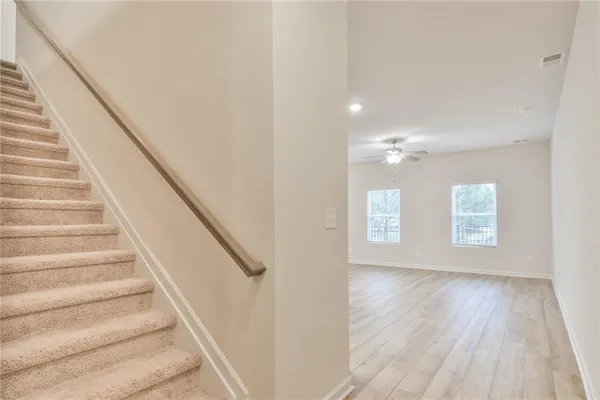 a view of entryway and hall with wooden floor