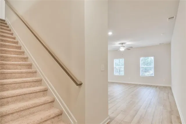 a view of entryway and hall with wooden floor