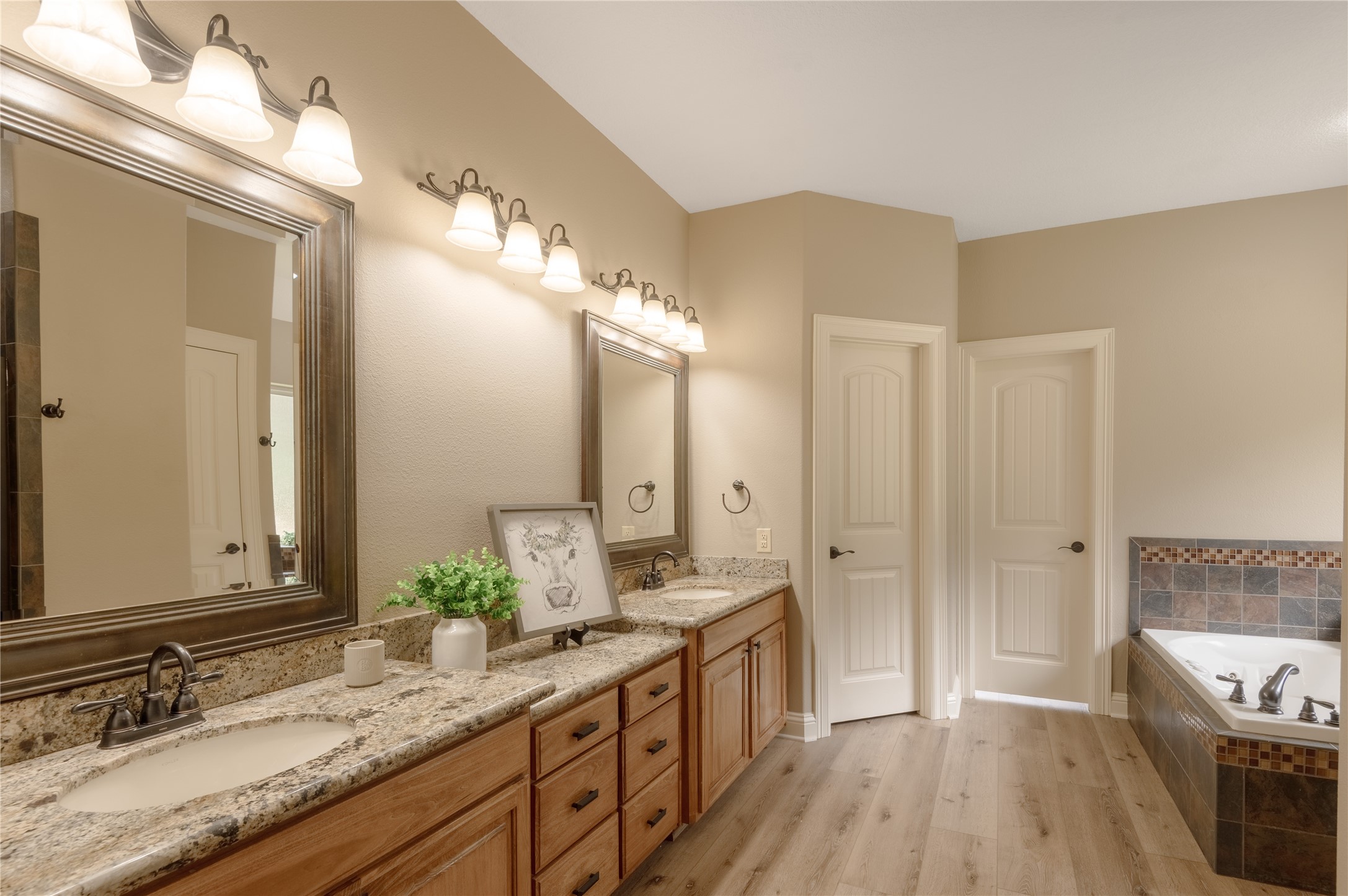 3134 Nursery Road Livingston, TX 77351 - Photo 22 of 50 In the primary bathroom are double sinks and a water closet (toilet room).