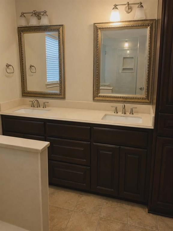 14752 Ranch Road Forney, TX 75126 - Photo 18 of 40 Dual vanity with dark wood-finish cabinetry and light-toned countertops-This photo was taken before family moved in