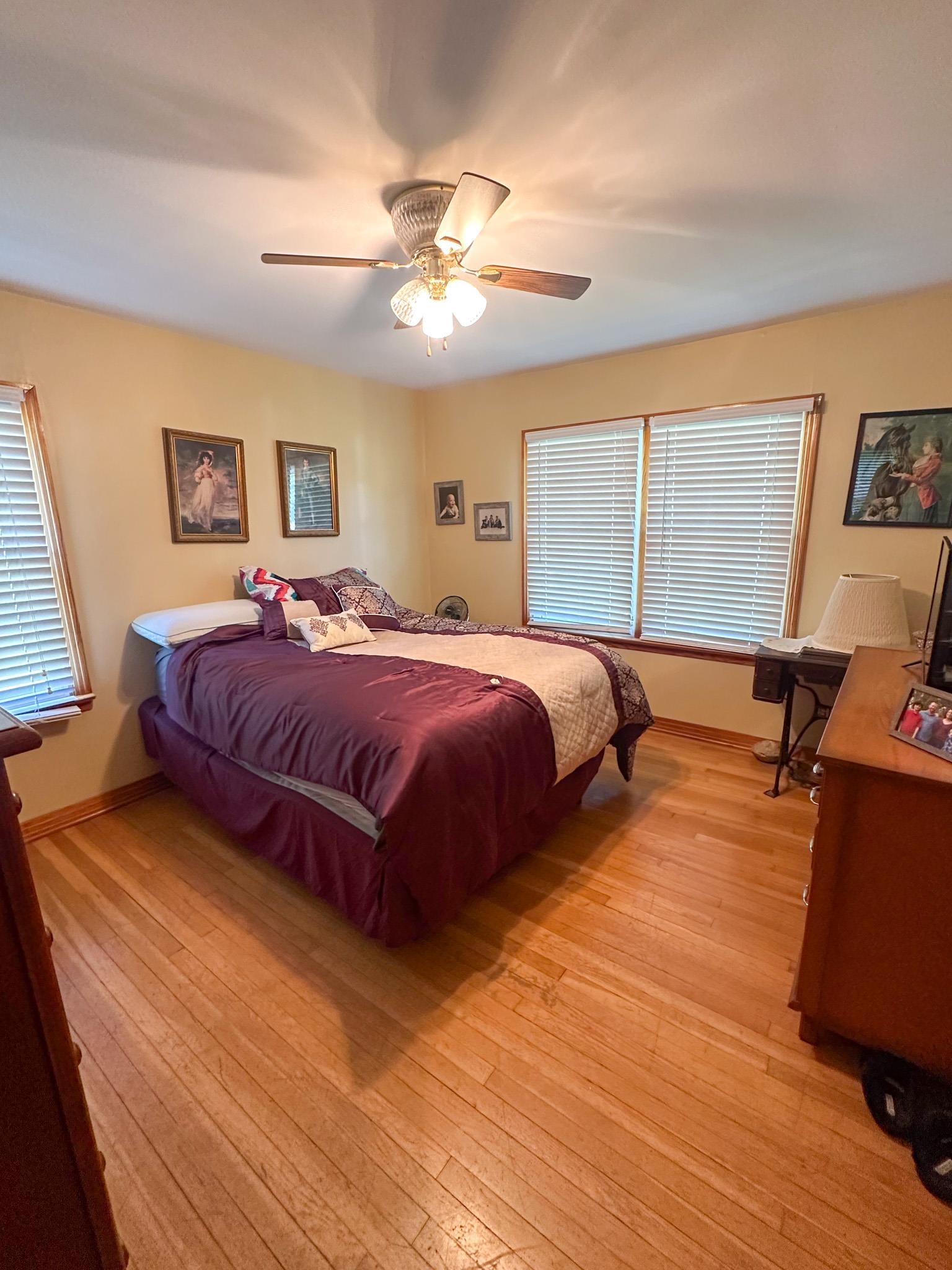 1650 6th Street Cherokee, AL 35616 - Photo 9 of 12 a bedroom with a bed and wooden floor