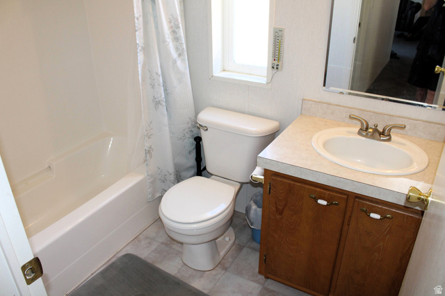 22580 Spring Creek Drive, Unit B61 Fairview, UT 84629 - Photo 30 of 39 Bathroom featuring a white bathtub, a toilet, a vanity with a drop-in sink, and a framed wall mirror