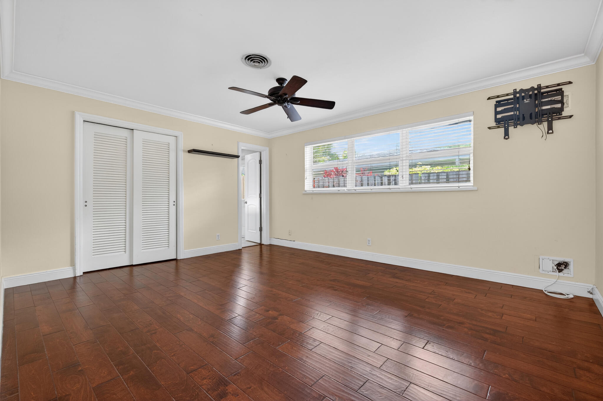 701 Southwest 5th Street Boca Raton, FL 33486 - Photo 13 of 19 a view of a room with wooden floor and ceiling fan