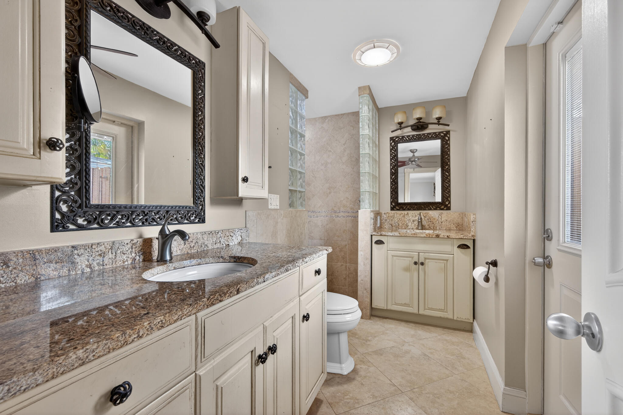 701 Southwest 5th Street Boca Raton, FL 33486 - Photo 14 of 19 a bathroom with a granite countertop sink double vanity and a mirror