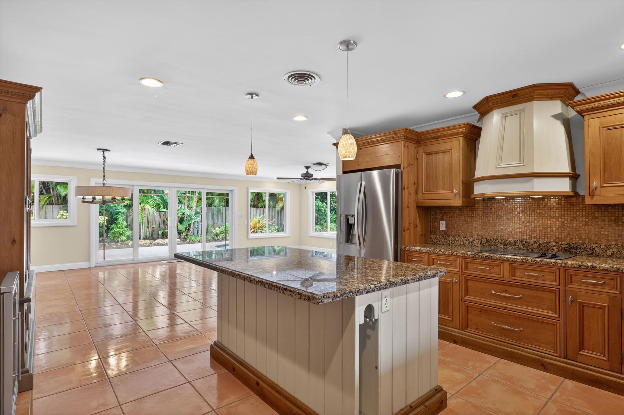 701 Southwest 5th Street Boca Raton, FL 33486 - Photo 10 of 19 a kitchen with stainless steel appliances granite countertop a sink a stove and a refrigerator