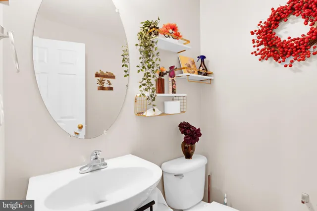 a view of staircase with lots of frames on wall and a window