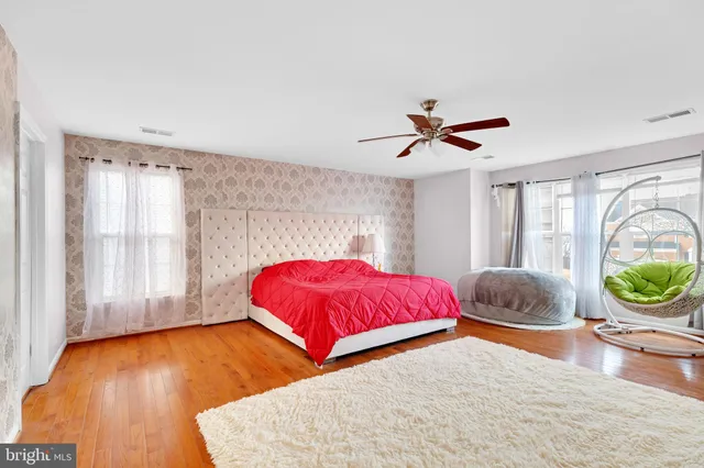 a spacious bedroom with a bed and a shower