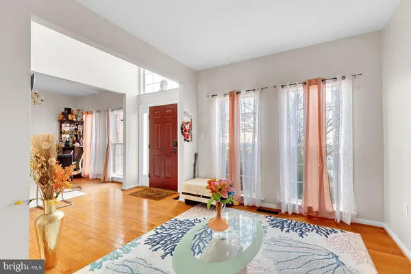 a bedroom with a bed and large windows