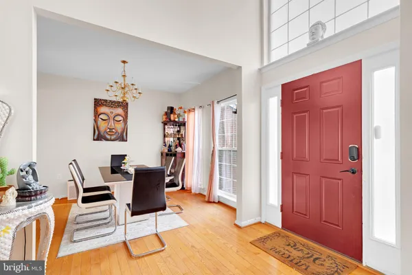 a view of a livingroom with a chair and front door