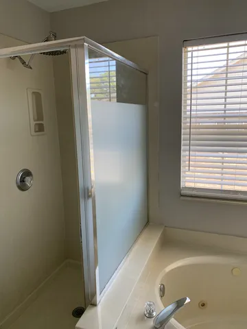 a bathroom with a shower and a sink