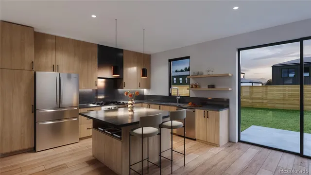 a kitchen with kitchen island granite countertop a sink stove and refrigerator