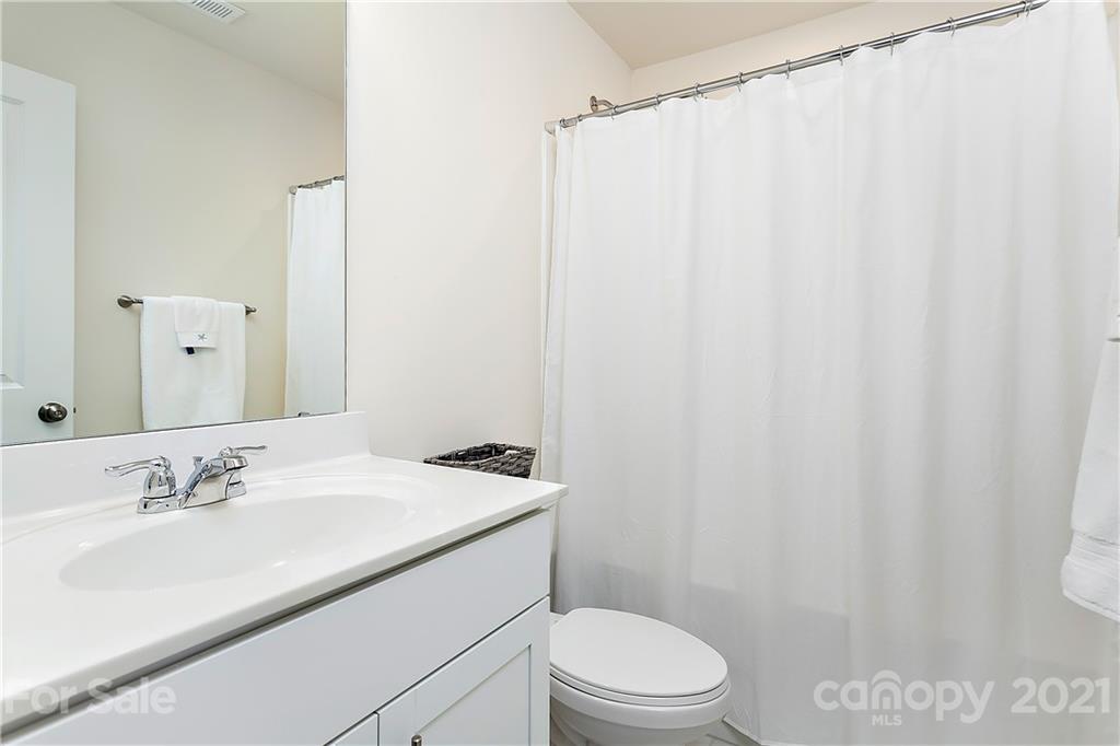 501 Hunters Dance Road Fort Mill, SC 29708 - Photo 11 of 16 a bathroom with a sink a toilet and shower curtain
