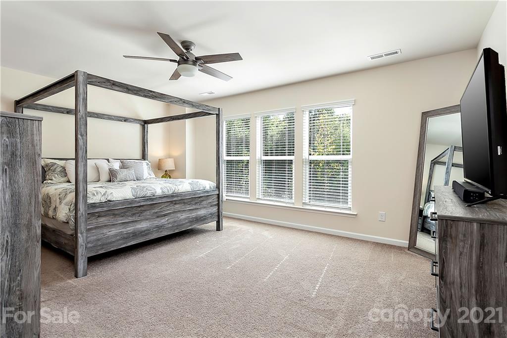 501 Hunters Dance Road Fort Mill, SC 29708 - Photo 7 of 16 a bedroom with a bed window and a ceiling fan