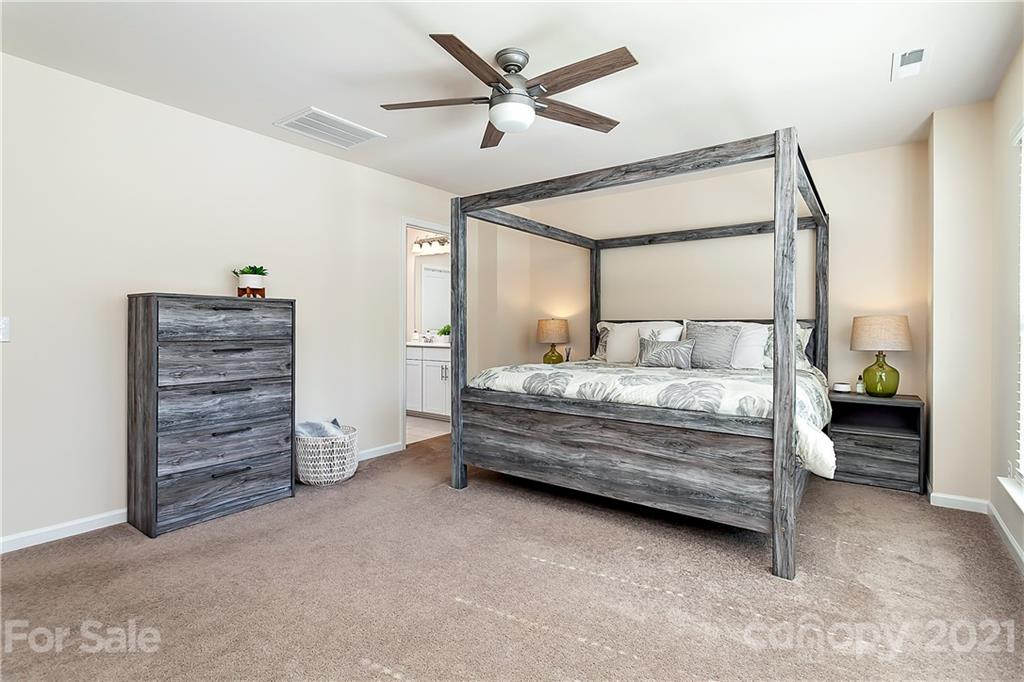 501 Hunters Dance Road Fort Mill, SC 29708 - Photo 8 of 16 a bedroom with a bed and a chandelier