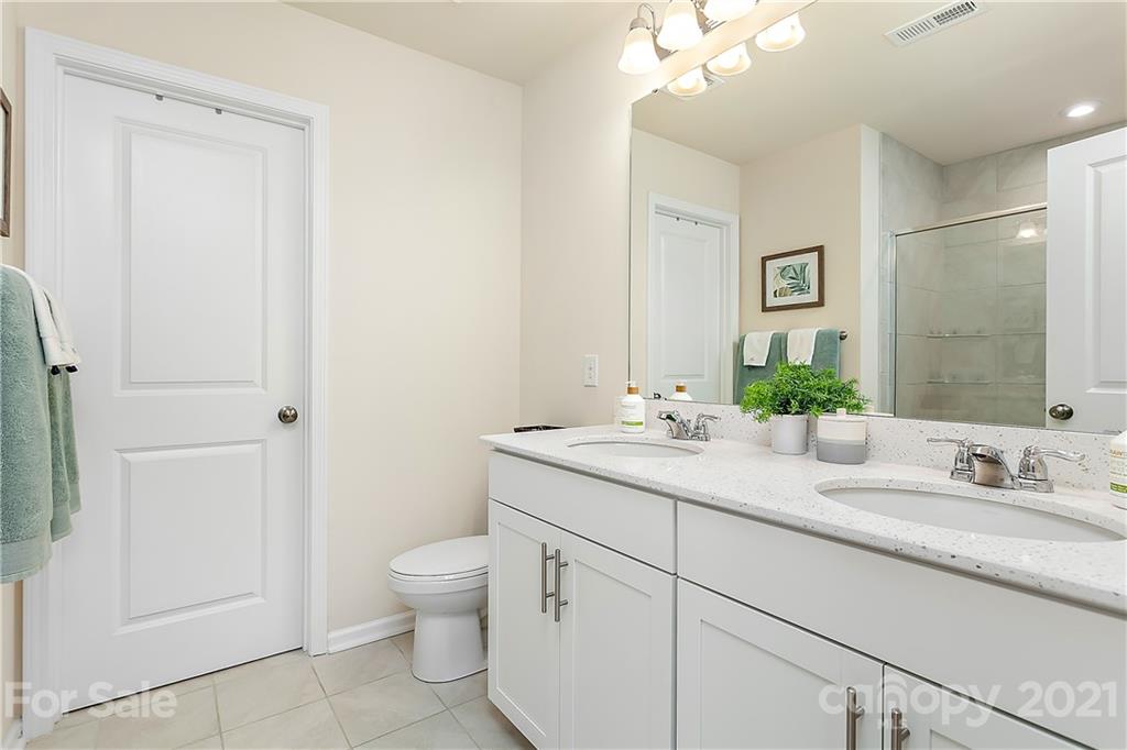 501 Hunters Dance Road Fort Mill, SC 29708 - Photo 9 of 16 a bathroom with a granite countertop sink a toilet and a mirror