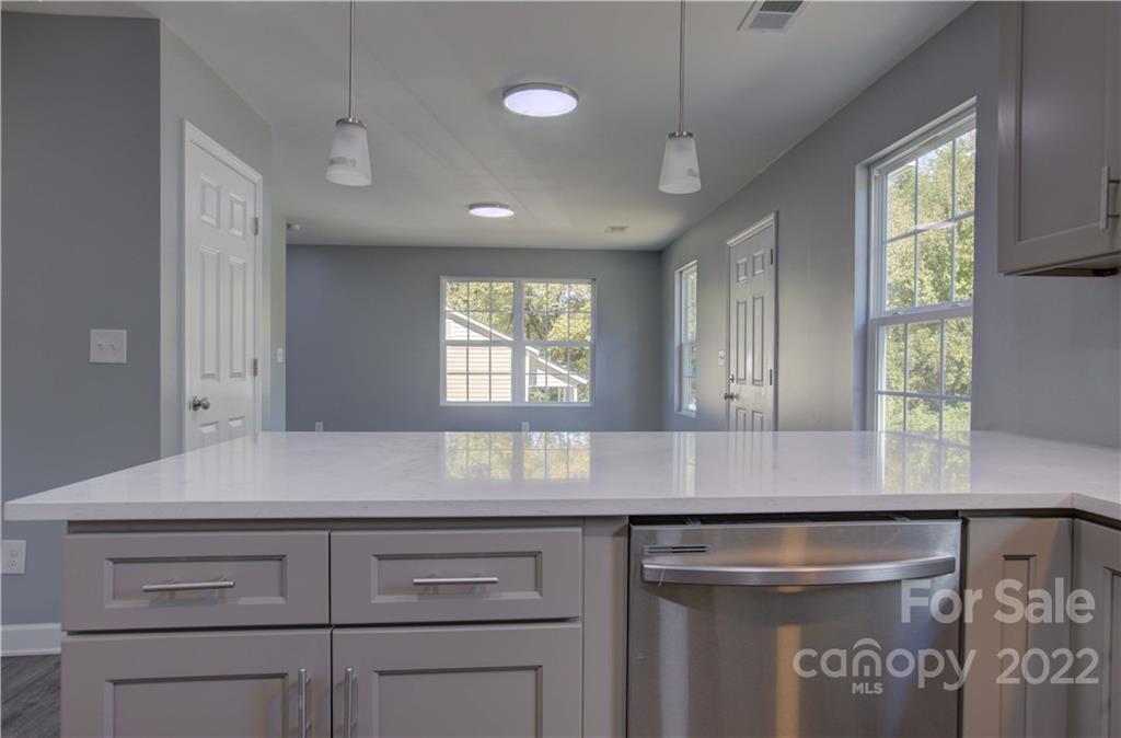 1129 5th Street Lancaster, SC 29720 - Photo 16 of 37 a kitchen with kitchen island a counter space a sink and a window
