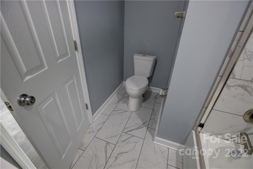 1129 5th Street Lancaster, SC 29720 - Photo 23 of 37 a bathroom with a toilet and a shower