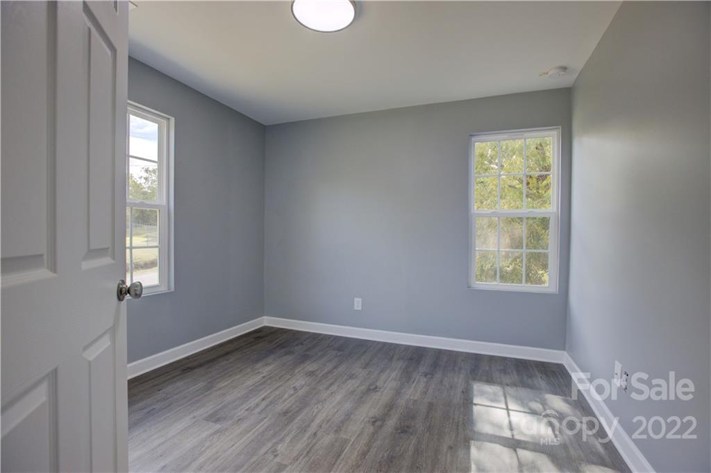 1129 5th Street Lancaster, SC 29720 - Photo 24 of 37 a view of an empty room with wooden floor and a window
